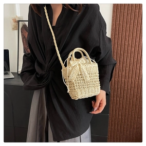 Detailed view of beige woven bucket bag with lace bow and drawstring liner