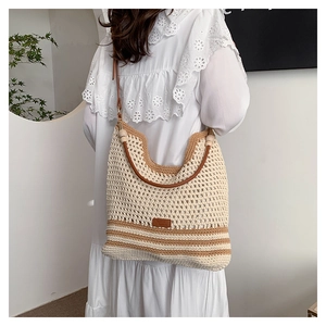 Bohemian style hollow woven shoulder bag with leather straps and wooden beads detail