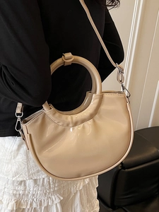 Chic beige patent leather crescent handbag with circular handle for women