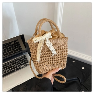 Detail of khaki woven beach bag with white lace bow and drawstring inner liner
