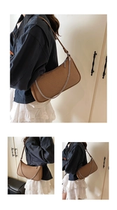 Close-up of brown woven texture shoulder bag featuring a decorative silver metal chain