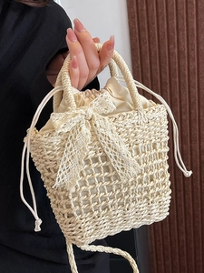 Beige woven straw handbag with white lace bow and drawstring liner for summer vacation