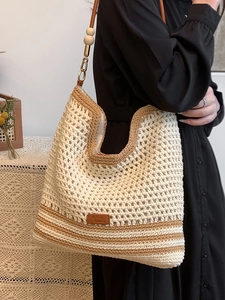 Minimalist woven tote bag in contrast colors with leather straps and wooden bead details