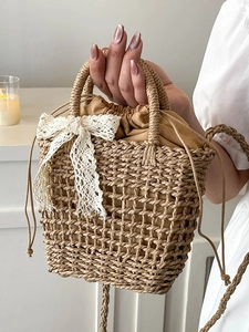 Handwoven straw tote bag with lace bow and drawstring liner for summer beach vacation
