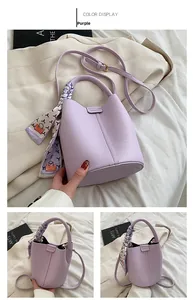 Detail of purple litchi texture bucket bag with silk scarf handle and metal closure
