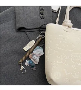 Detail of cute dog acrylic charm with silver plate on embossed leather bucket bag