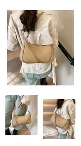 Detailed close-up of woven straw underarm bag with leather strap and silver chain