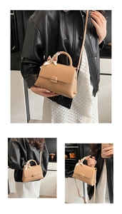 Detail of beige lychee pattern leather handbag with scarf handle and metal clasp