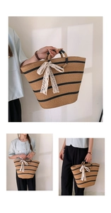 Detail of hand-woven straw tote with black stripes and a large white lace bow accent