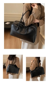 Close-up of black tote bag featuring premium lychee texture and silver zipper detail