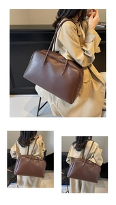 Macro detail of the dark brown lychee grain leather and secure zipper closure of the bag
