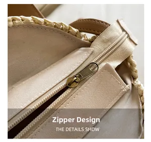 Detailed macro view showing the beige fabric lining and vintage bronze zipper closure