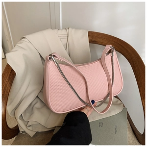 Detailed view of pink chain shoulder bag with woven texture and adjustable strap