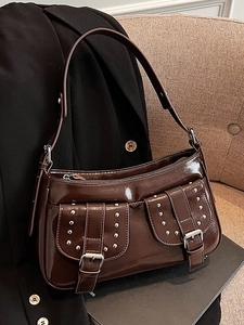 Dark brown patent leather underarm bag with punk silver rivets and biker style details