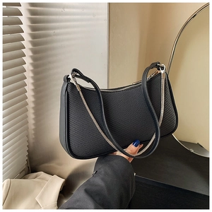 Detail of black crescent shoulder bag featuring twill texture and silver chain strap