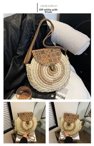 Detailed view of woven straw round bag with ethnic pattern flap and metal buckle