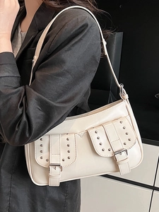 Chic beige underarm bag with glossy leather, metal rivets and double belt buckles