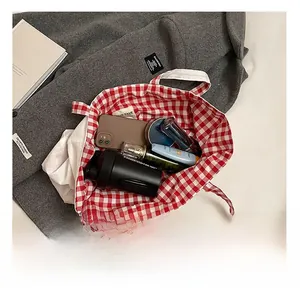 Top view of red plaid tote bag interior showing large capacity for phone and tumbler