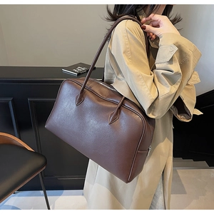 Detailed texture of dark brown litchi pattern faux leather on large tote bag