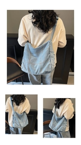 Detailed view of frayed side edges and stitching on the light blue denim shoulder bag