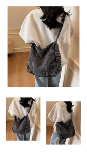 Detailed view of large charcoal denim hobo bag with vintage wash and white contrast stitching