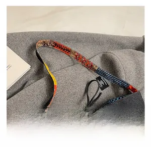Detail showing Bohemian colorful patchwork strap and denim fabric with brand label