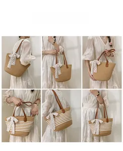 Detail showing natural straw woven tote bag with brown leather straps and white lace bow