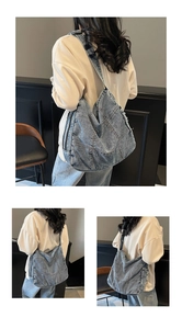 Detailed view of denim tote bag showing patchwork seams and side metal zipper texture