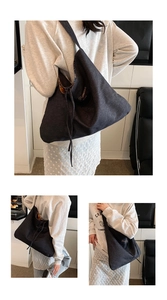 Close-up of charcoal gray canvas tote bag featuring Romance embroidery and drawstring closure