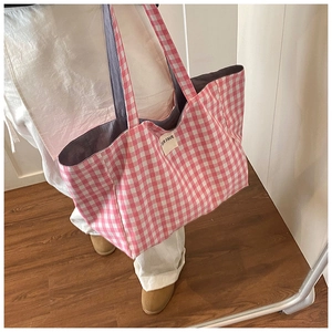 Detail of pink and white checkered tote bag with OUR FAVE label and purple lining