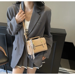 Chic beige crossbody square bag featuring decorative straps and a silk scarf tassel charm