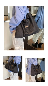 Macro detail of dark blue denim tote bag showing functional front pocket and drawstring closure