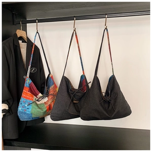 Detail of bohemian patchwork and solid hobo tote bags with drawstring closure