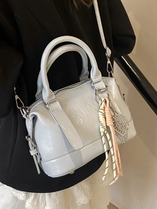Chic blue matte leather Boston bag with embossed letters and tennis racket charm