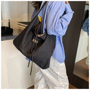 Detail of bohemian denim tote bag with drawstring closure and colorful printed lining