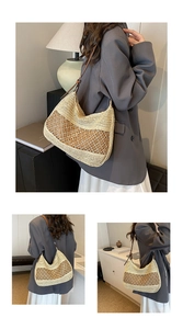 Detailed view of woven straw tote bag featuring brown leather strap and intricate hollow pattern