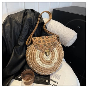 Detail of round straw bag with ethnic patterned cork flap and vintage metal buckle