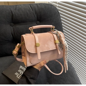 Pink velvet mini square bag with metal accents and decorative silk scarf handle