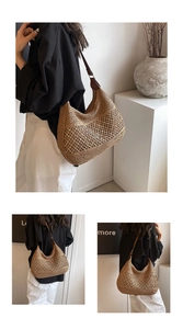 Detailed view of hollow woven straw tote bag with adjustable brown leather shoulder strap
