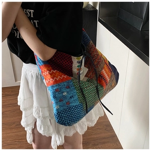 Detailed shot of bohemian patchwork tote bag featuring drawstring closure and fabric textures