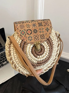 Ethnic straw circular crossbody bag featuring retro floral prints and a metal buckle
