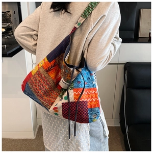 Detail view of colorful patchwork tote bag with bohemian patterns and drawstring design