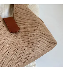 Detailed macro view of the herringbone knit texture and soft fabric on the tote bag