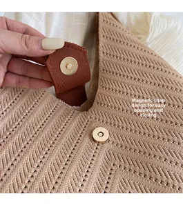 Detail of khaki woven tote bag with metallic magnetic clasp closure for easy access
