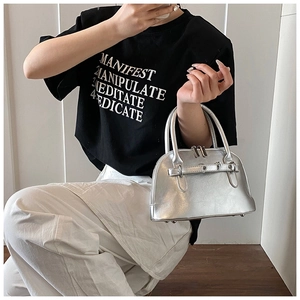 Detailed side view of silver metallic shell bag with stylish buckle and smooth zipper