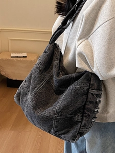 Minimalist black denim tote bag with contrast stitching and frayed edges for daily commute