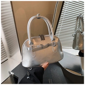 Detail view of liquid silver dome bag featuring metallic texture and double zip closure