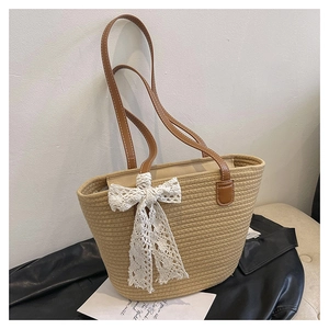 Detailed macro view of woven beige tote texture with lace bow and leather handles
