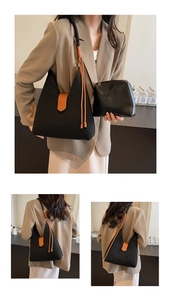 Detail of black woven hobo tote bag featuring a V-shaped knit texture and accessory pouch
