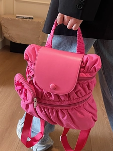 Pink pleated nylon backpack with matching bow pouch and matte flap closure